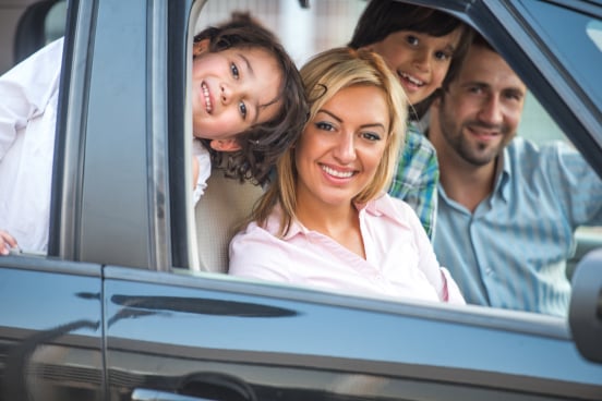 Family smiling with low interest car loan